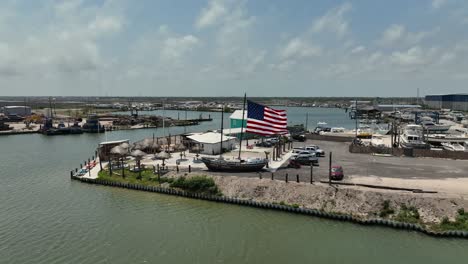 Aerial-Point-of-view-of-waterfront-restaurants-and-bars-in-Rockport,-Texas-in-4K