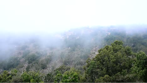 Timelapse-of-the-mist-of-the-clouds-with-green-mountains-and-trees