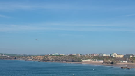 Wide-Angle-View-Of-Newquay-Harbour-In-Cornwall,-UK-With-Helicopter-Flying-In-Distance