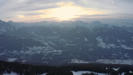 Sunset-in-Austrian-alps,-aerial-drone-footage-of-ski-resort-Patscherkofel,-pull-back-movement