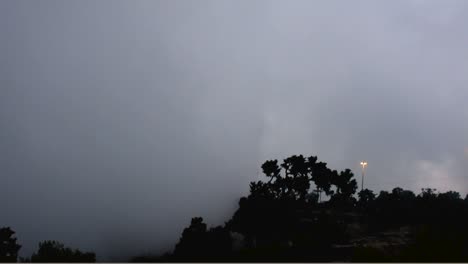 Timelapse-of-the-mist-of-the-clouds-along-the-signal-tower-and-street-light