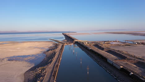 Pacific-Union-train-on-railroad-tracks-crossing-the-Great-Salt-Lake-in-Utah,-drone-view