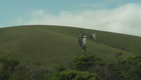 Windmill-in-front-of-Pastoral-California-Hills-Wide-Shot-4K
