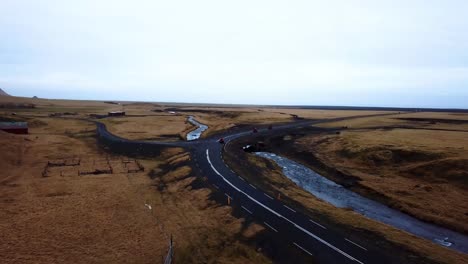 Aerial-landscape-view-of-red-quad-bikes-speeding-on-a-empty-road-through-Iceland-highlands