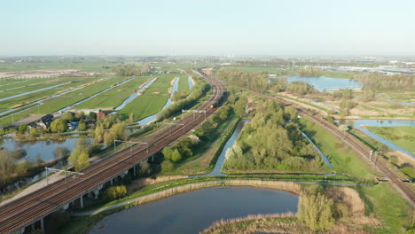 NS-Intercity-Train-On-The-Railway-Passing-By-Polder-In-Gouda,-Netherlands