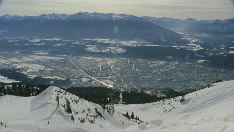 view-of-Innsbruck-from-Nordkette-ski-resort,-with-chairlift-and-skiers