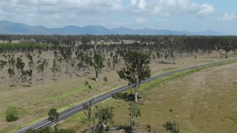 Deserted-road-crossing-rural-landscape-at-Bajool,-Queensland-in-Australia