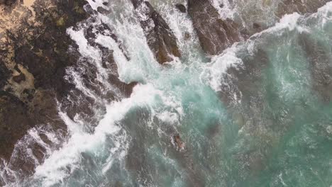 Overhead-view-of-waves-on-rocky-shore-in-Hawaii-static