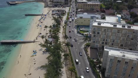 Aerial-drone-view-overlooking-traffic-on-the-west-bay-street,-in-sunny-Nassau,-Bahamas