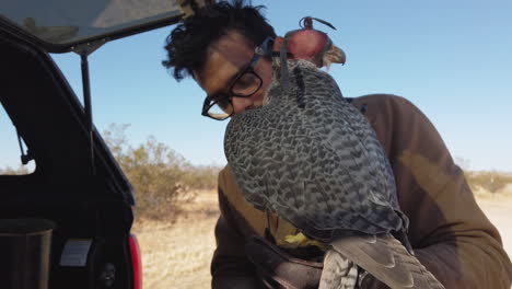 Tying-Falcon-With-Jess-To-Leather-Glove-Of-Falconer-In-A-Desert