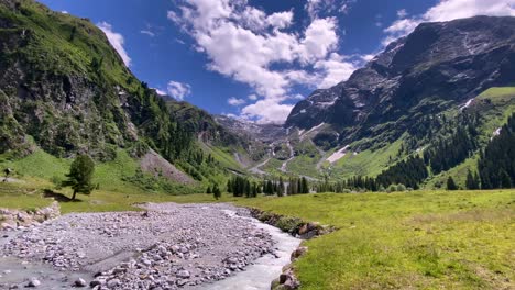 River-with-stones-in-the-beautiful-Lüsens-valley-in-Austria-with-high-mountains-and-blue-sky-in-the-background