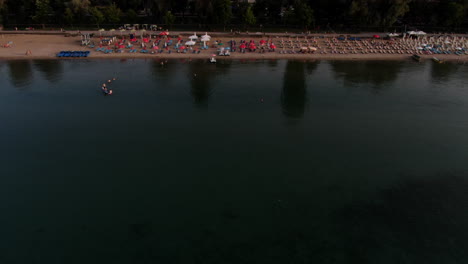 Vuelo-Sobre-El-Lago-Ohrid-Revelando-Con-Una-Hermosa-Ciudad-De-Pogradec-Inclinada-En-Albania,-Europa