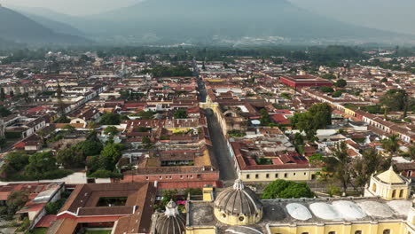 Slow-aerial-rotating-hyperlapse-of-the-arch-and-churches-in-downtown-Antigua,-Guatemala