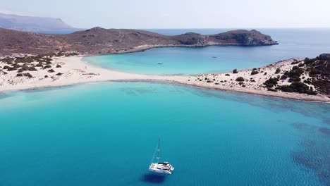 Luxury-Boat-and-White-Sandy-Beach-at-Elafonisos,-Peloponnese,-Greece---Aerial