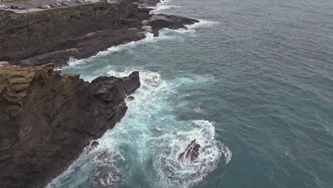 Aerial-view-of-rocky-cliffs-along-pacific-ocean-tracking-forward