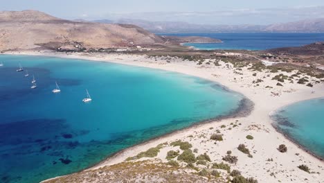 Luxury-Boats-at-Tropical-Beach-in-Elafonisos,-Peloponnese,-Greece---Aerial