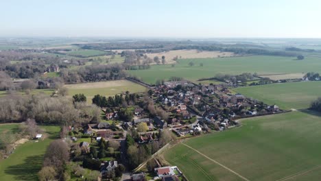 Idyllic-aerial-view-above-Nonington-small-town-farming-countryside-settlement-and-fields-push-in-right