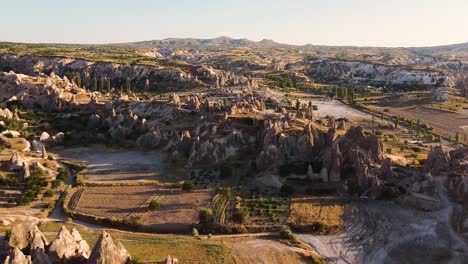 Aerial-shot-approaching-rock-formation-in-Cappadocia-during-golden-hour