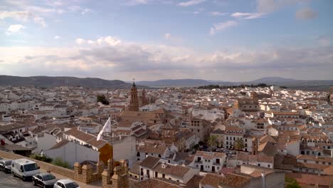 Slow-motion-sweeping-shot-over-medium-sized-town-in-Andalusia,-Spain
