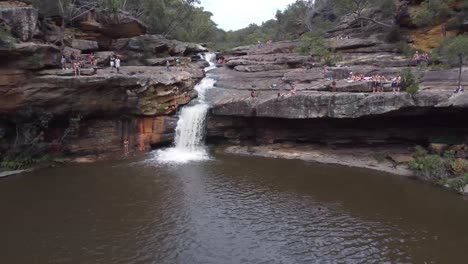 Aerial-footage-of-people-jumping-into-waterfall