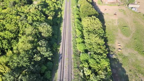 Aerial-shot-of-the-train-tracks,-revealing-the-transit-train-at-the-city-station