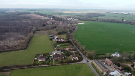 Peaceful-aerial-view-above-Nonington-rural-small-town-rustic-land-borders-countryside-flying-forwards