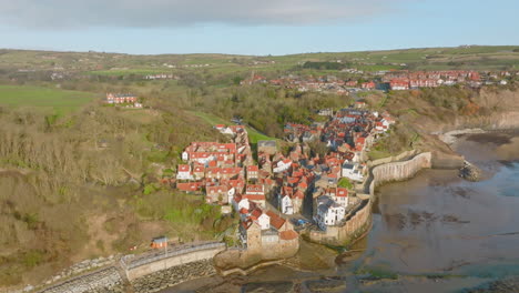 North-York-Moors-Heritage-Coast,-Robin-Hoods-Bay,-Aerial-drone-flight-over-RHB-village,-rotating-around-the-slipway-out-at-sea-DJI-Mavic-3-Cine-Prores-422-March-2022-Clip-4