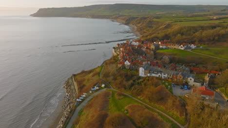 North-York-Moors-Heritage-Coast,-Robin-Hoods-Bay,-Aerial-drone-flight-over-RHB-village-early-morning-north-to-south-DJI-Mavic-3-Cine-Prores-422-March-2022-Clip-1