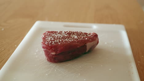 Salting-a-piece-of-steak-tenderloin-or-filet-mignon-in-preparation-for-cooking