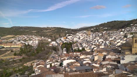 Panorama-slow-motion-pan-across-small-village-in-Andalusia-with-round-church