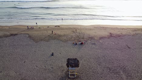 Drone-video-of-people-on-a-beach-shore-in-Lima,-Peru