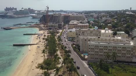 Aerial-view-of-traffic-on-the-bay-street-in-downtown-Nassau-in-the-Bahamas-islands---tilt,-drone-shot