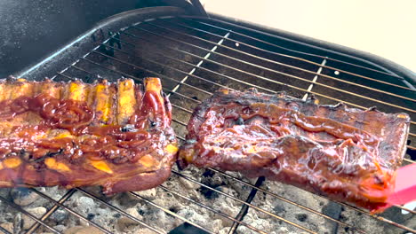 Grilling-and-basting-BBQ-pork-ribs-with-brush
