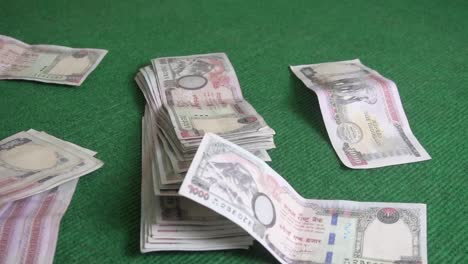 Nepali-currency-falling-on-the-table