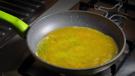 Chef-is-pouring-beaten-eggs-into-pan,-Cooking-scrambled-eggs-for-lunch