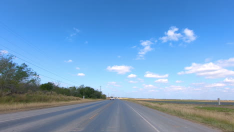 POV-driving-through-rural-Rio-Grande-Valley-in-southern-Texas-past-vegetable-fields