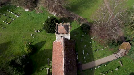 Drone-over-the-top-of-an-old-English-church-in-the-village-of-Bekesbourne-with-roof-damage-4K