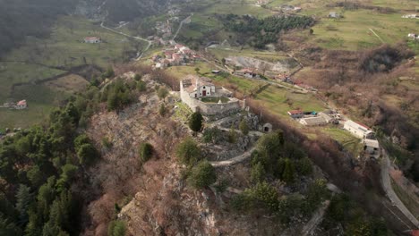 Aerial-circle-view-of-sanctuary-perched-on-the-hill-in-a-valley