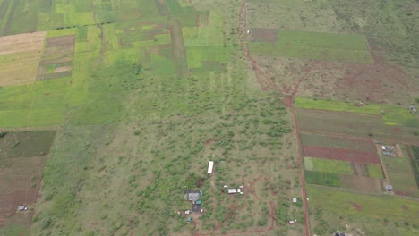 Countryside-and-farmlands-in-Southern-Kenya,-contemporary-agriculture-in-Africa,-aerial-tilt-down