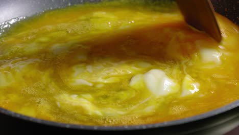 Close-up-View-of-Person-Cooking-Scrambled-Eggs-on-a-Hot-Frying-Pan