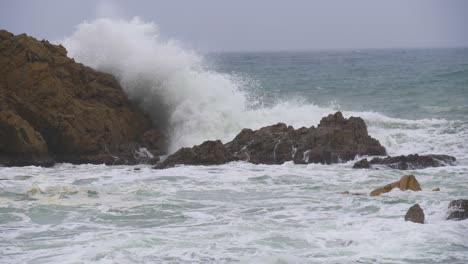 Sea-storm-in-Blanes-giant-waves-in-super-slow-motion-breaking-against-the-rocks-Mediterranean-sea-Costa-Brava-winter-cloudy-day
