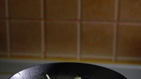 Close-up-View-of-Sliced-Cabbage-Bowl,-Cooking-Scrambled-Eggs---Tilt-Shot