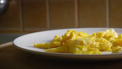 Close-up-View-of-Delicious-Scrambled-Eggs-on-a-Plate---Truck-Shot
