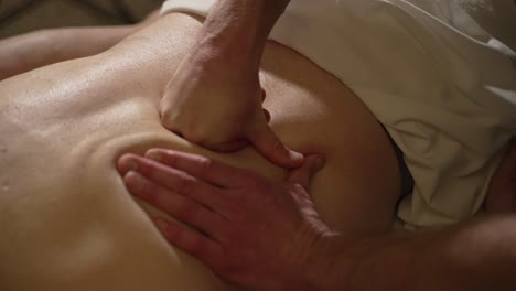 Therapist-Massaging-and-Kneading-Male-Patient-Back-With-Hands-and-Knuckles