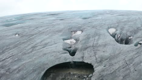 Ascending-aerial-shot-of-famous-Breidamerkurjokull-Glacier-Snout-in-Iceland---Visiting-Vatnajökull-National-Park
