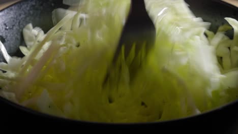 Close-up-view-of-Forks-Mixing-Sliced-Cabbage-in-a-Bowl---Steady-Shot