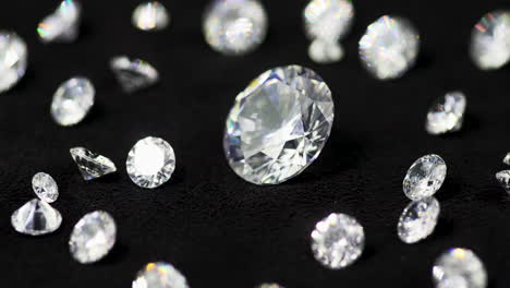 Real-brilliant-cut-shining-diamonds-of-various-sizes-on-the-turntable-rotating-clockwise-shallow-DOF-close-up---highly-valuable-and-expensive-gemstones-for-fashion-and-weddings