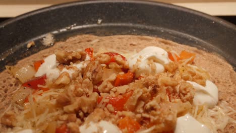 French-Buckwheat-Crepe-With-Toppings-Cooking-On-A-Non-stick-Pan