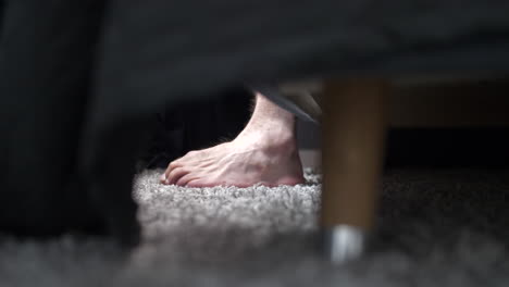 Close-up-of-a-man's-Caucasian-feet-getting-out-of-bed