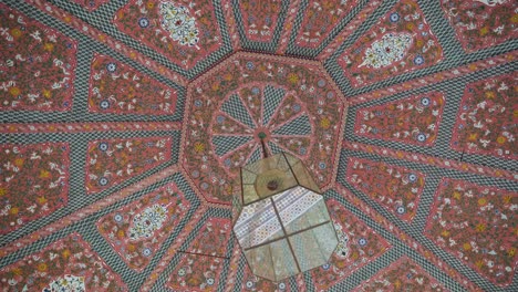 Decorative-colorful-pattern-ceilings-with-lamp-in-Morocco,-rotate-handheld-view